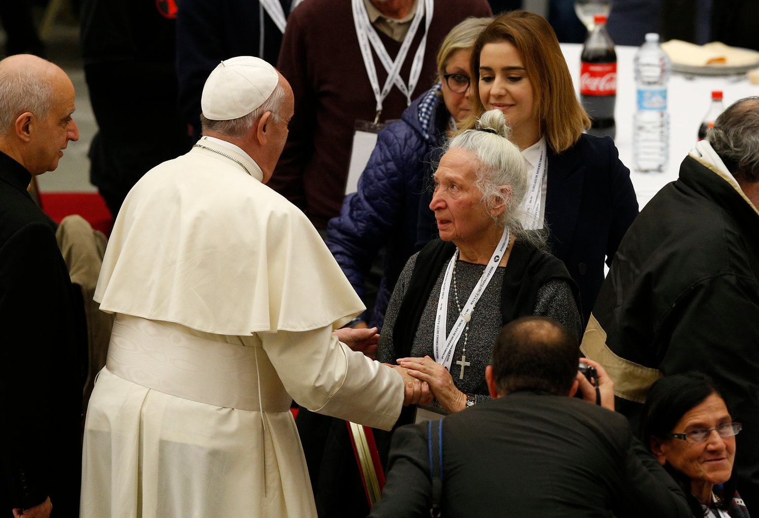 Pope Francis greets a woman as he arrives to eat lunch with the poor in the Paul VI hall as he marks World Day of the Poor at the Vatican Nov. 17, 2019.